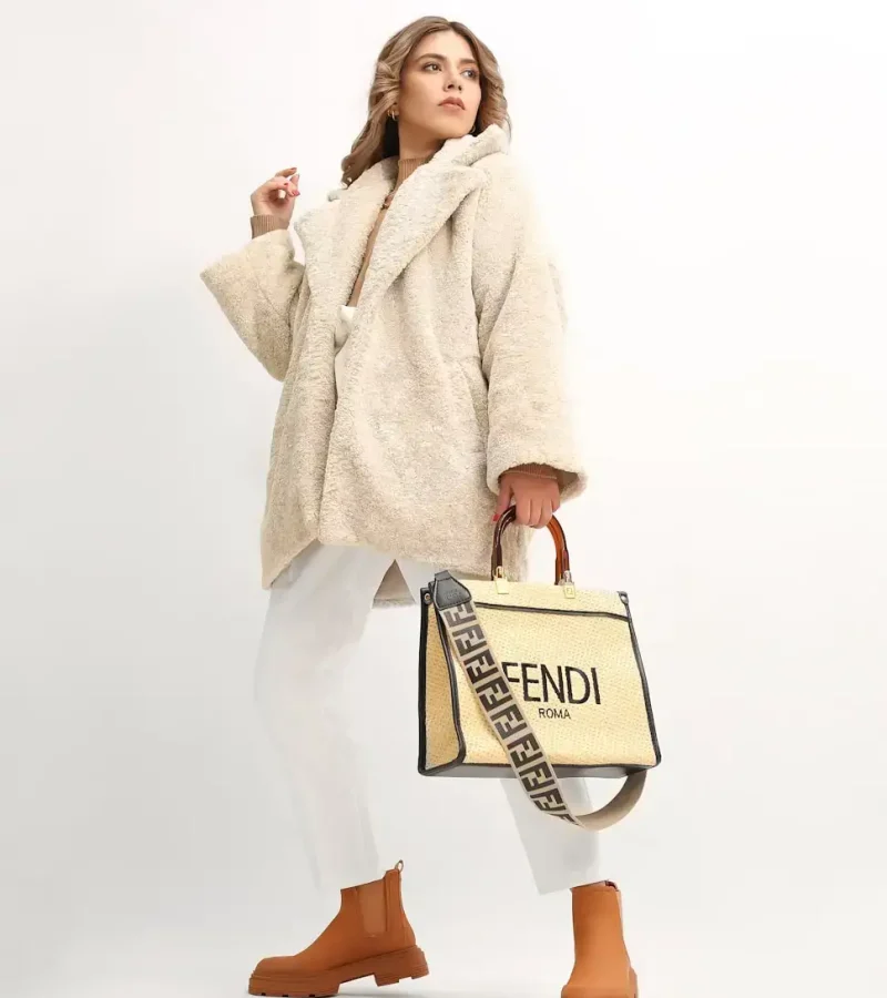 a woman in a fur coat holding a fendi bag